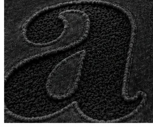 Close-up of the tonal reverse-appliqué lettering