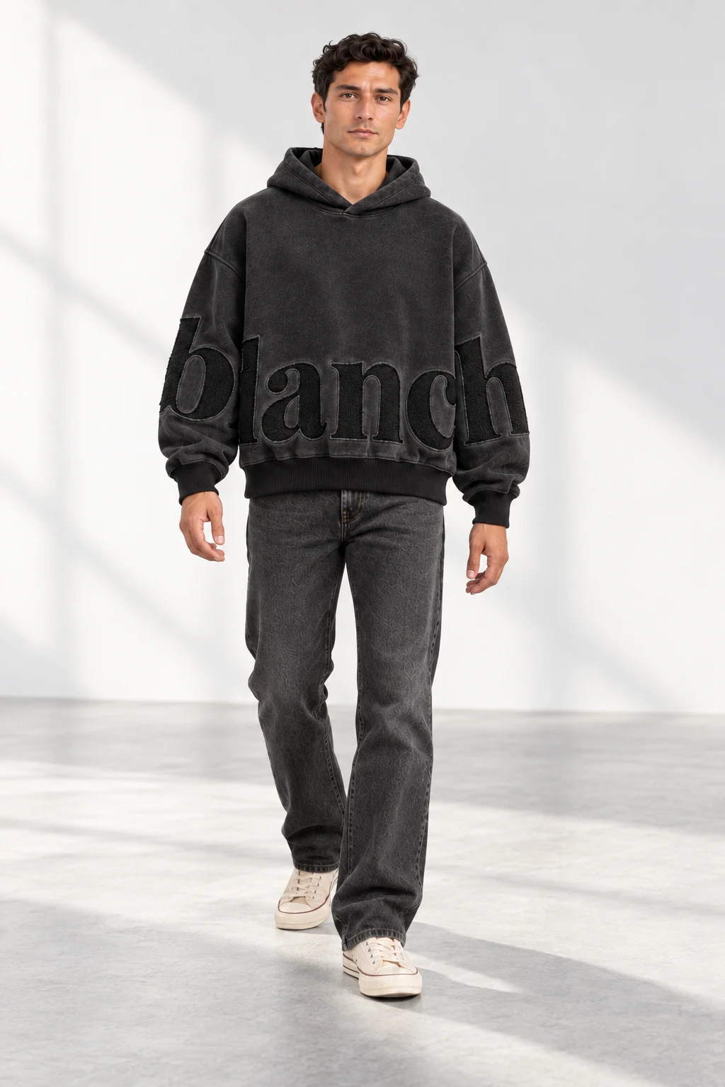 Close to the Cloth tonal hoodie, worn with relaxed black trousers